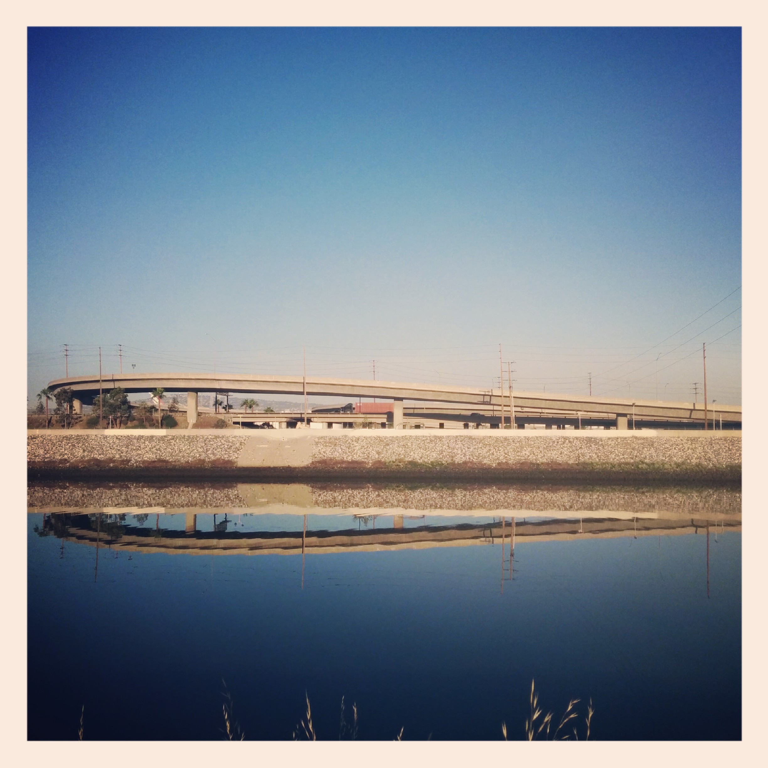 Got an early start today. I was really happy to leave that motel and hit the road.
And was greeted by the LA River here looking all serene and reflecty